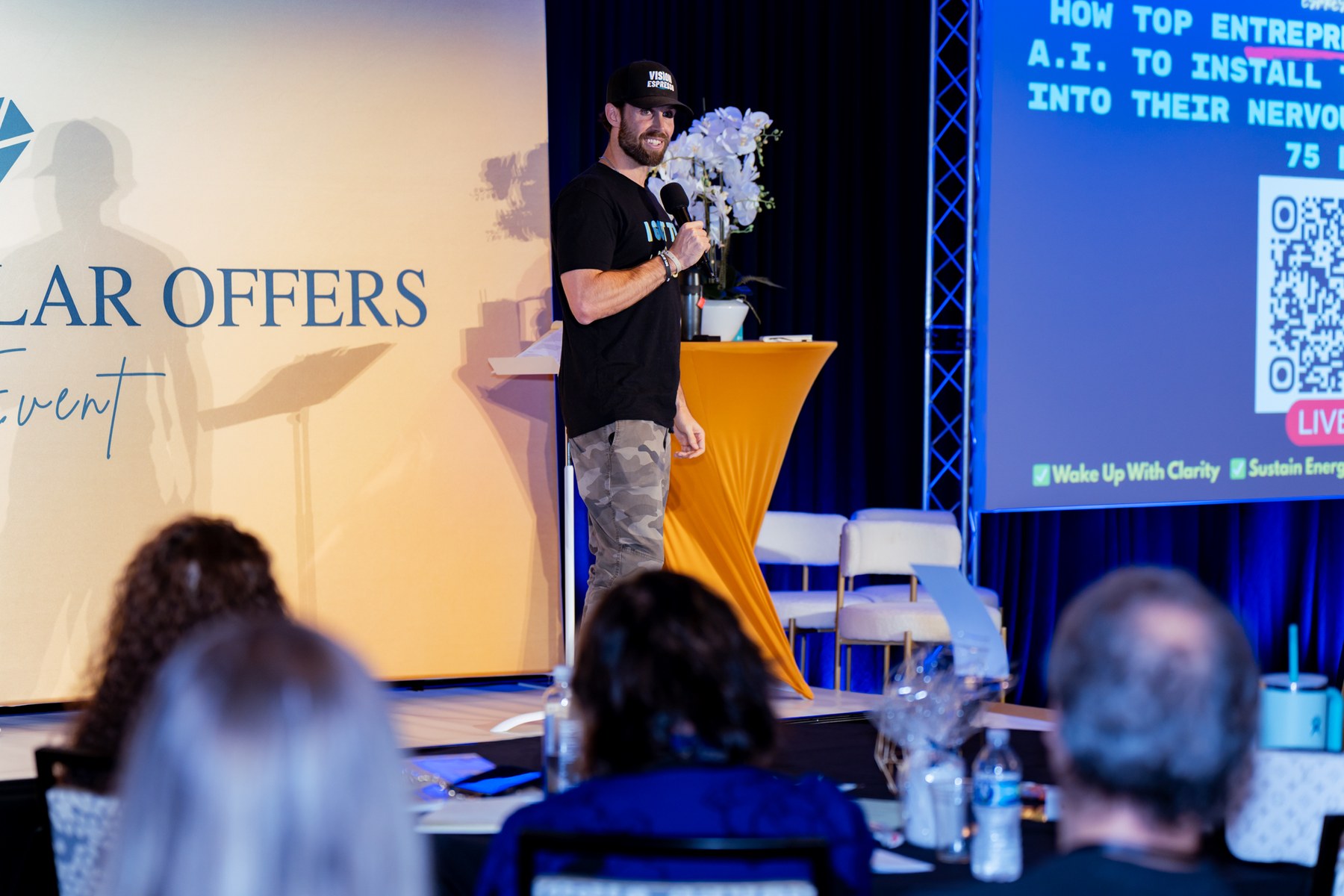 Niko Arapkiles speaking on stage